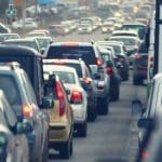 Drivers in major cities in the U.S. are losing hours each year to traffic. Image Source: Kichigan/Canva